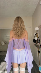 Back view of model showing adjustable lace-up back on lavender corset mini dress