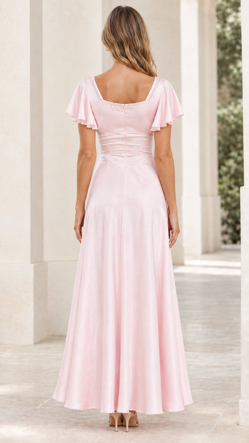 Back view of blush pink satin maxi dress displaying square back neckline and concealed zipper