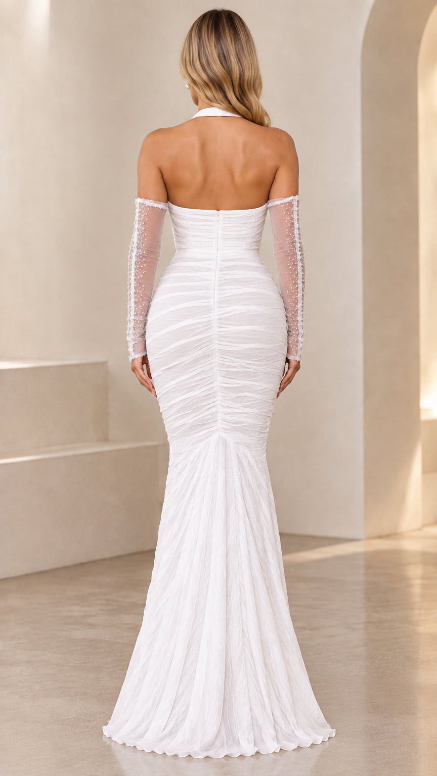 Back view of woman in white halter maxi dress showcasing the open back and back zipper closure