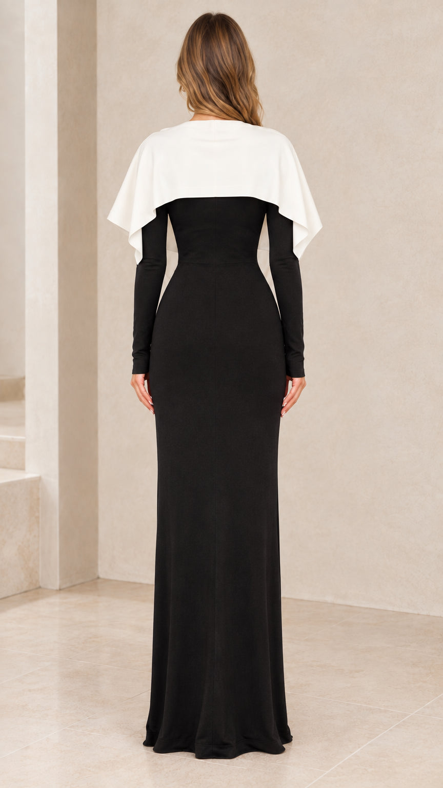 Back view of black long sleeve evening maxi dress with cape detail