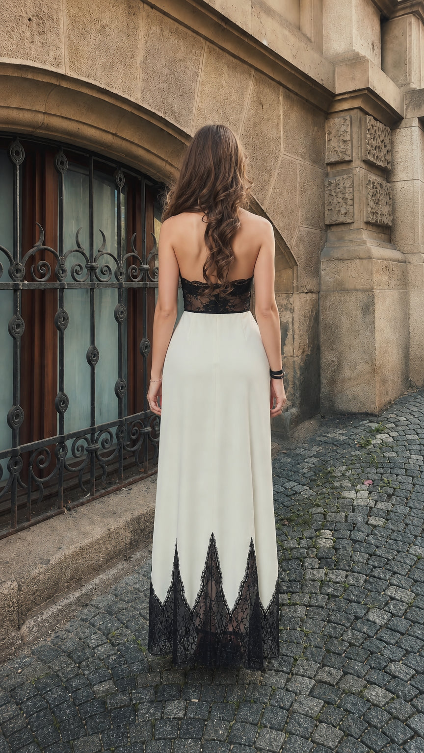 Back view of woman wearing ivory lace halter maxi dress showing open back