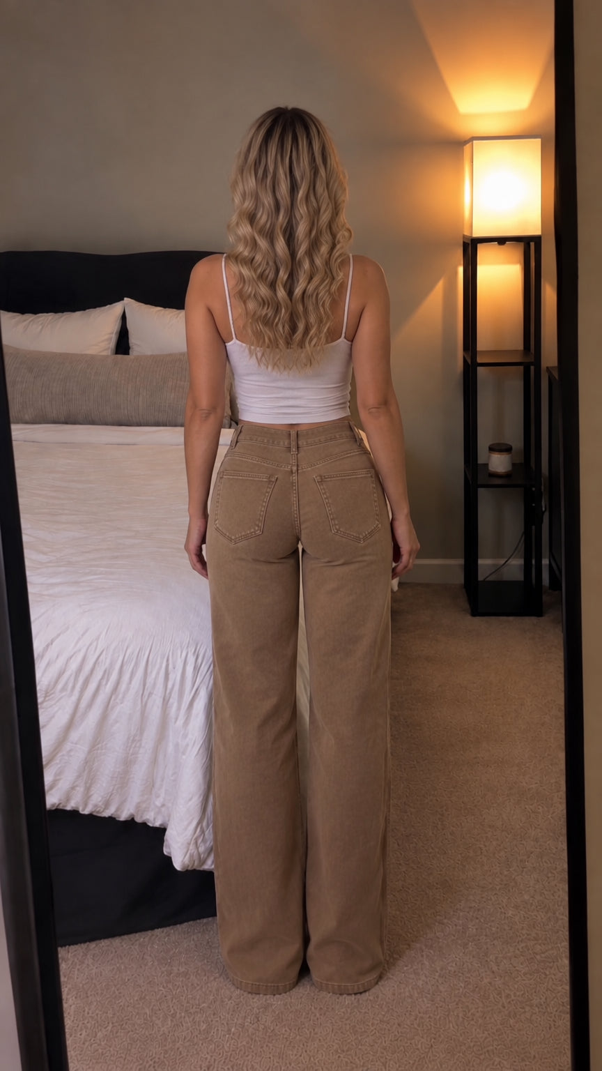 Back view of woman wearing khaki brown wide-leg jeans with back patch pockets