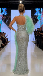Back view of one-shoulder silver sequin gown on the runway