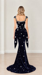 Back full-length view of navy blue star-embellished velvet evening dress highlighting back neckline and train