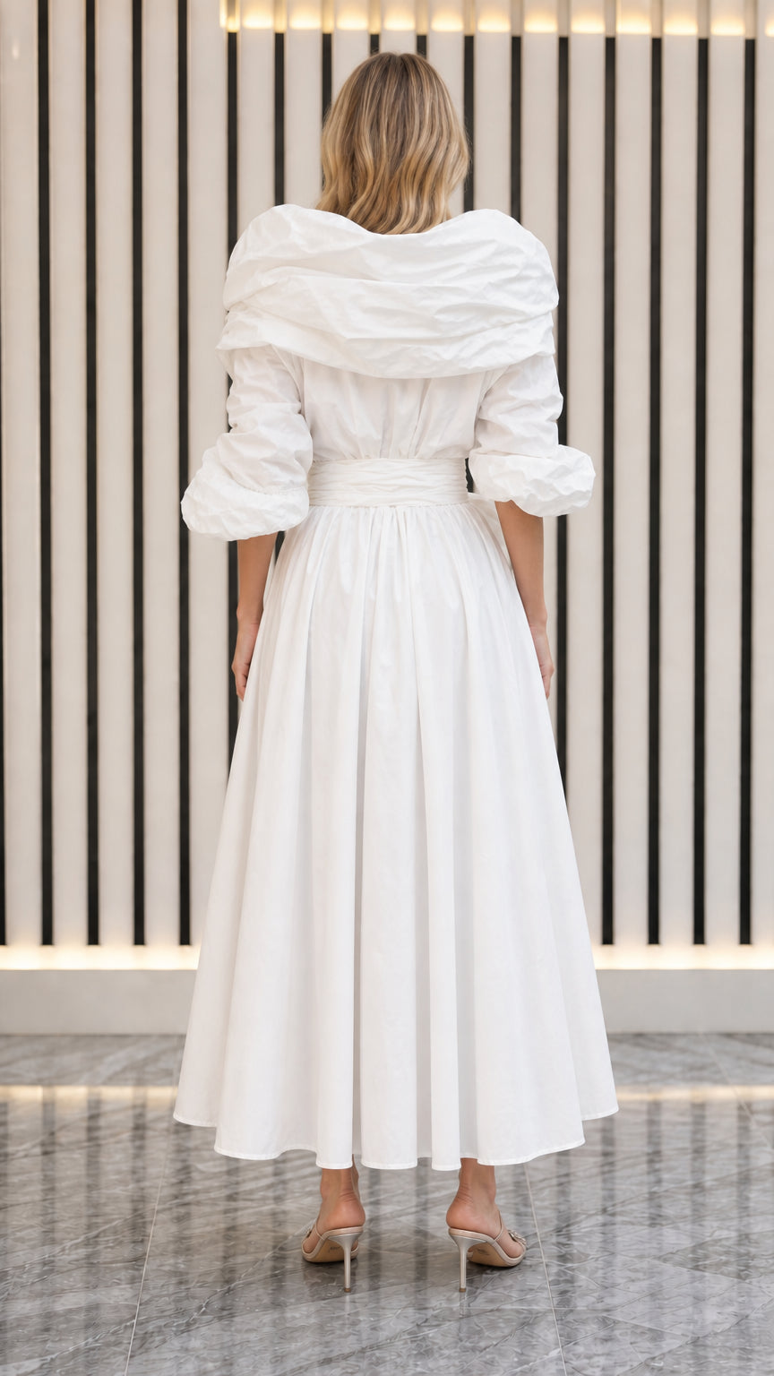 Back view of model in white pleated maxi dress showing collar structure