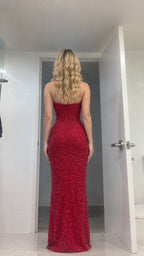 Back view of model wearing red strapless sequin maxi gown showcasing fitted rear silhouette