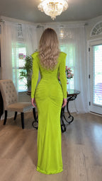 Back view highlighting ruched detailing and floor-skimming hem on lime green gown