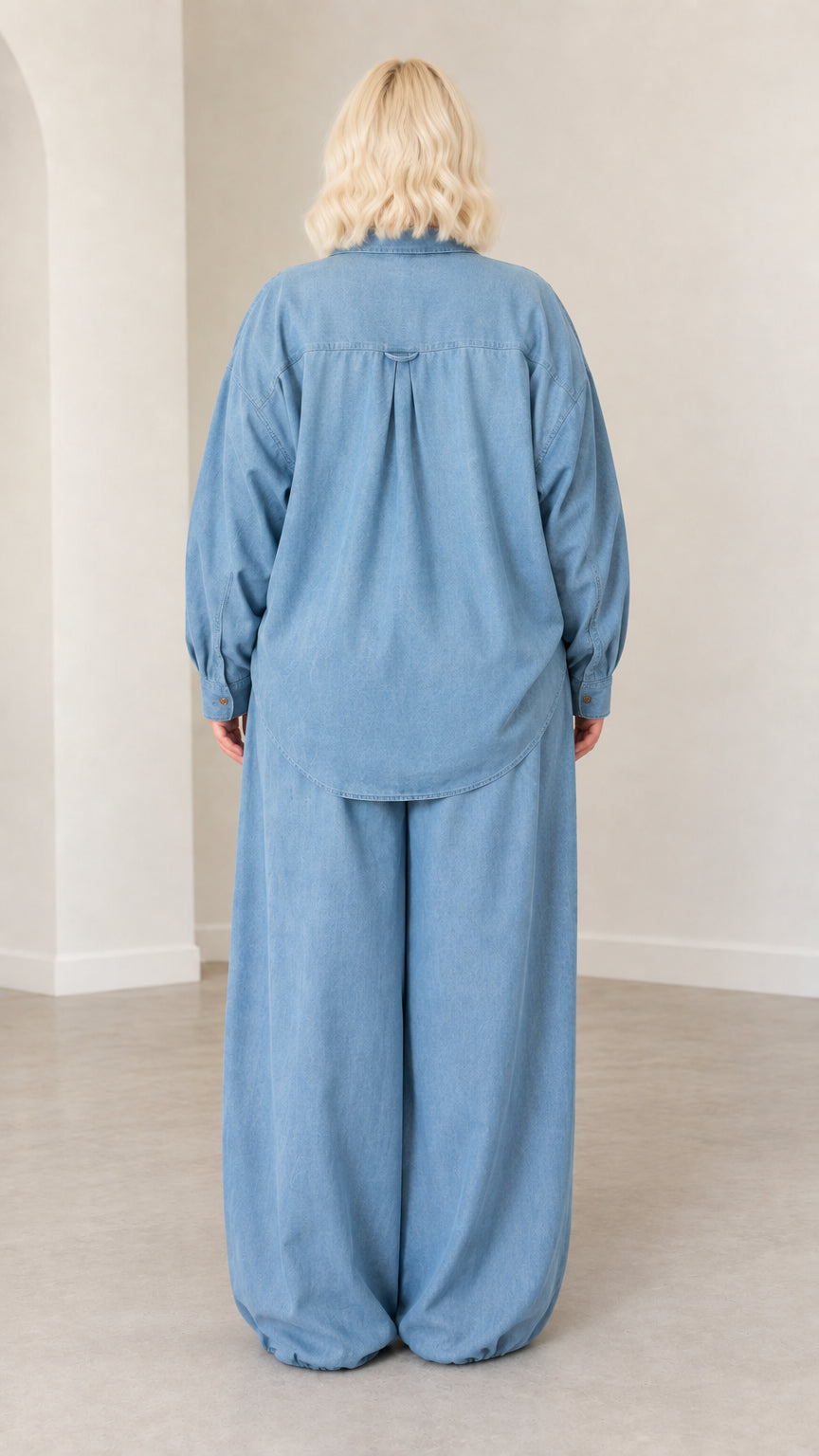 Back view of model wearing Light Blue long-sleeve collared shirt and elastic waist pants set