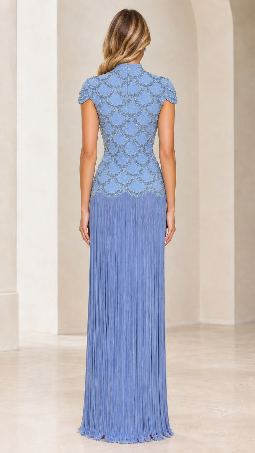 Back view of light blue mock neck beaded maxi dress with cascading fringe skirt