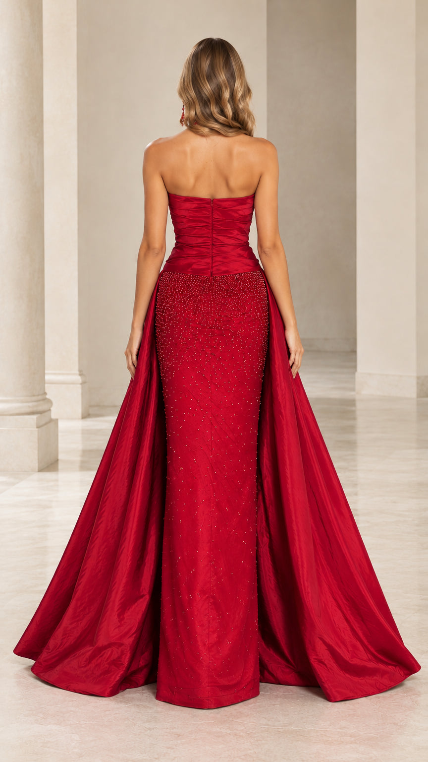 Back view of model showing the back zip and sweeping train of the red evening gown