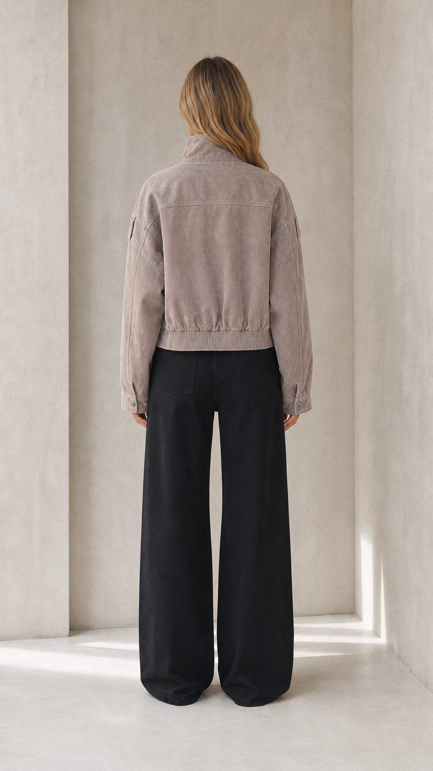 Back view of taupe cropped faux suede jacket with gathered waistband