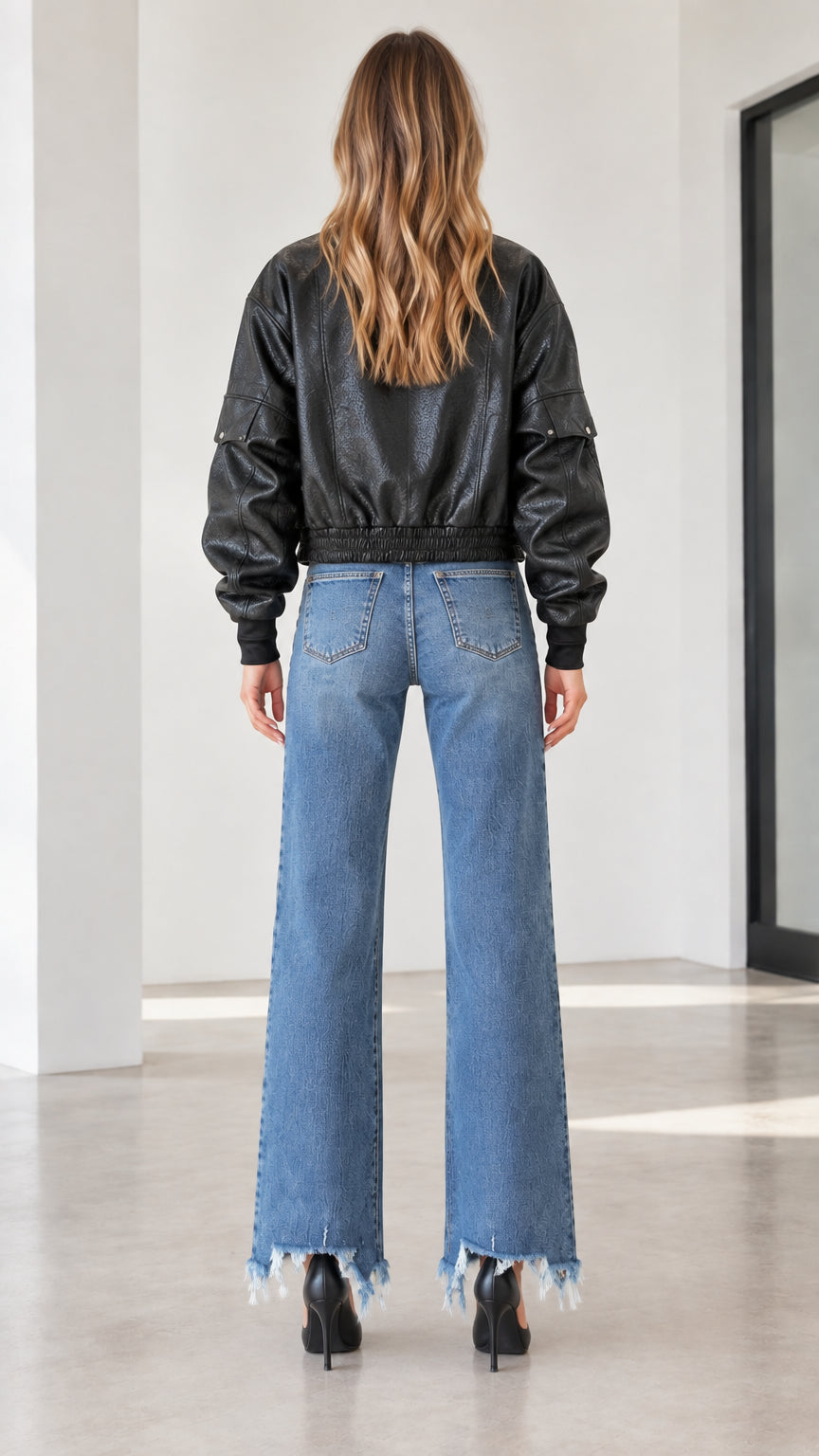 Back view of the black textured faux leather bomber jacket showing relaxed fit and ribbed hem