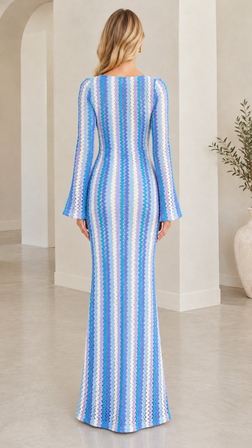Back view of model in Blue Multi chevron stripe knit evening gown