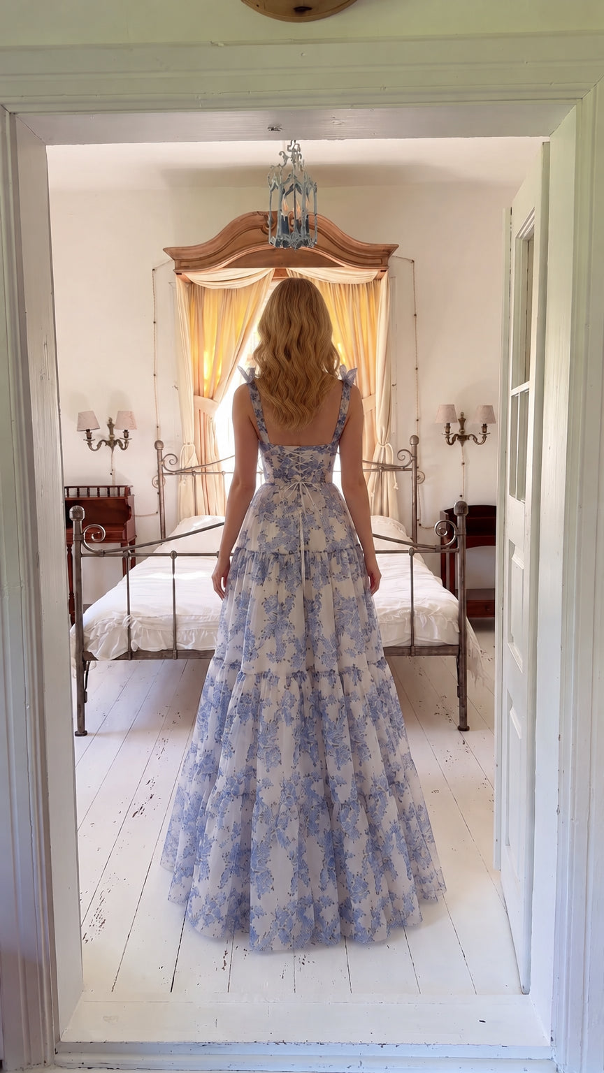 Back view of woman wearing blue floral corset maxi dress with lace-up back detail