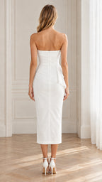 Back view of model wearing white strapless sheath midi dress with zipper closure