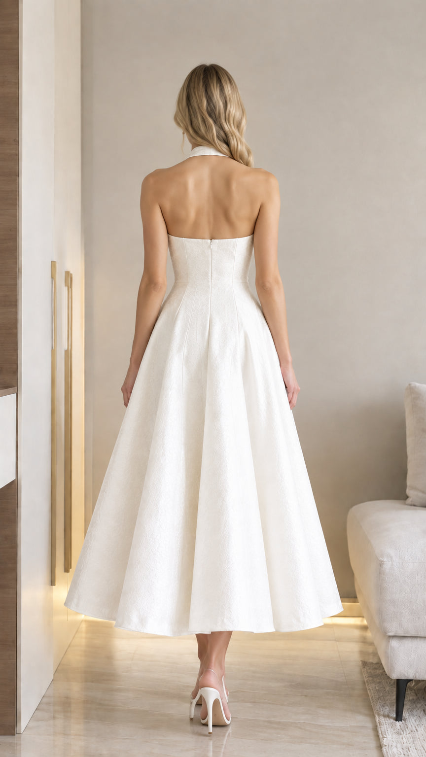 Back view of model wearing white halter backless jacquard A-line midi dress