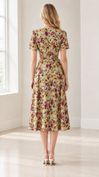 Back full-length view of sage green floral wrap midi dress with flared skirt