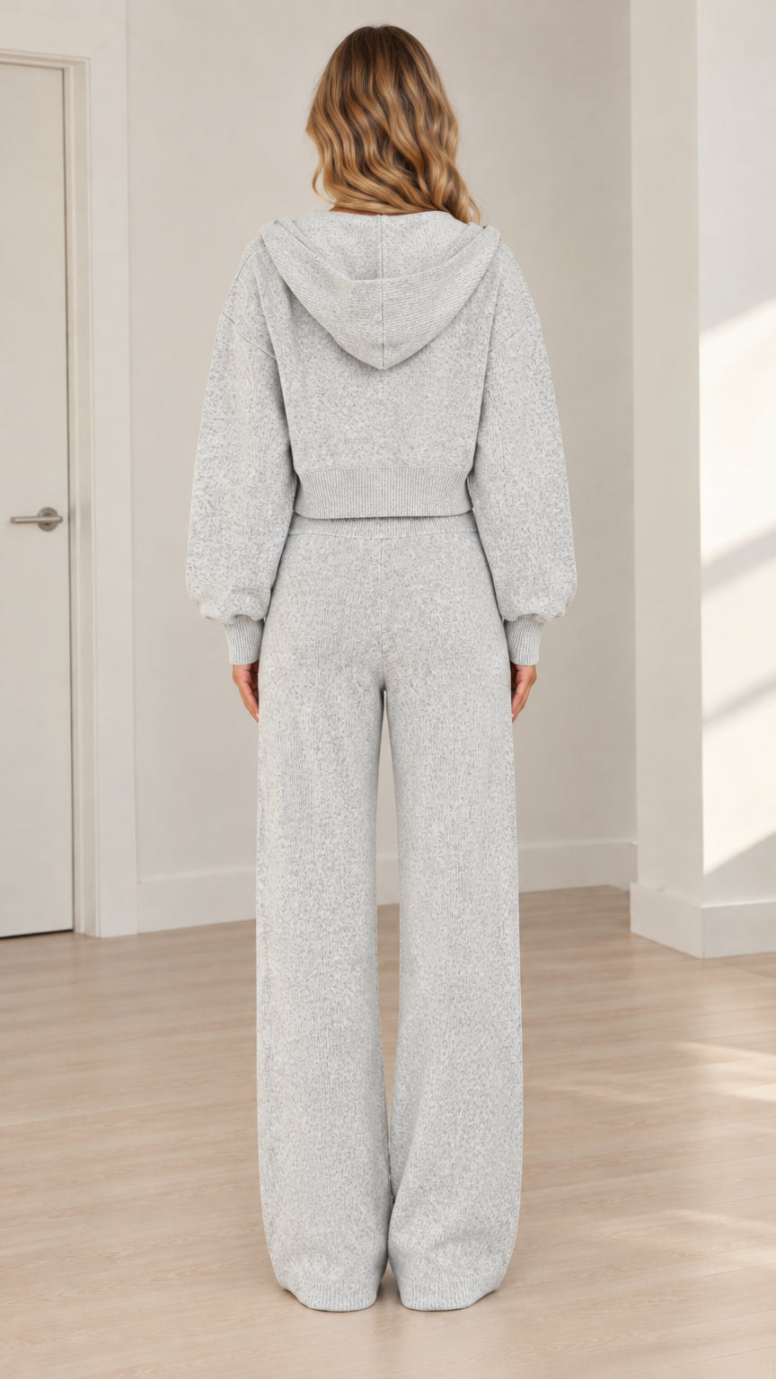 Back view of model wearing heather grey hooded jacket and wide-leg lounge pants