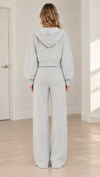 Back view of model wearing heather grey hooded jacket and wide-leg lounge pants