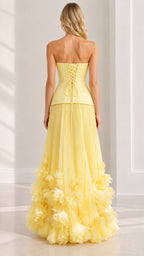 Back view of pastel yellow formal gown featuring lace-up corset detail and floral hem