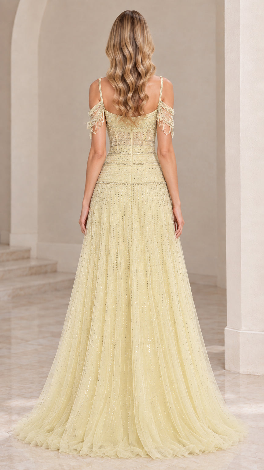 Back view of light yellow evening dress with zipper closure and shoulder fringe