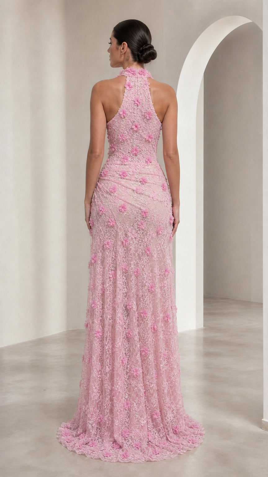 Back view of model in Blush Pink halter neck formal gown with train