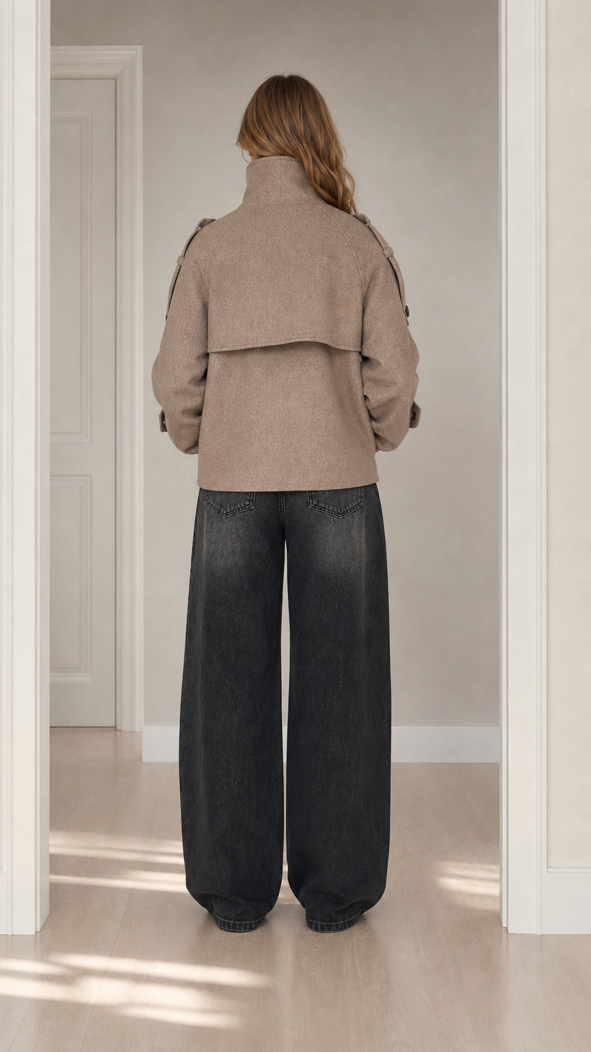 Back view of taupe short wool coat highlighting storm flap detail and relaxed fit