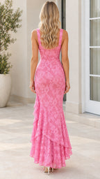 Back view of model in pink floral evening maxi dress showing square back and fluted hem