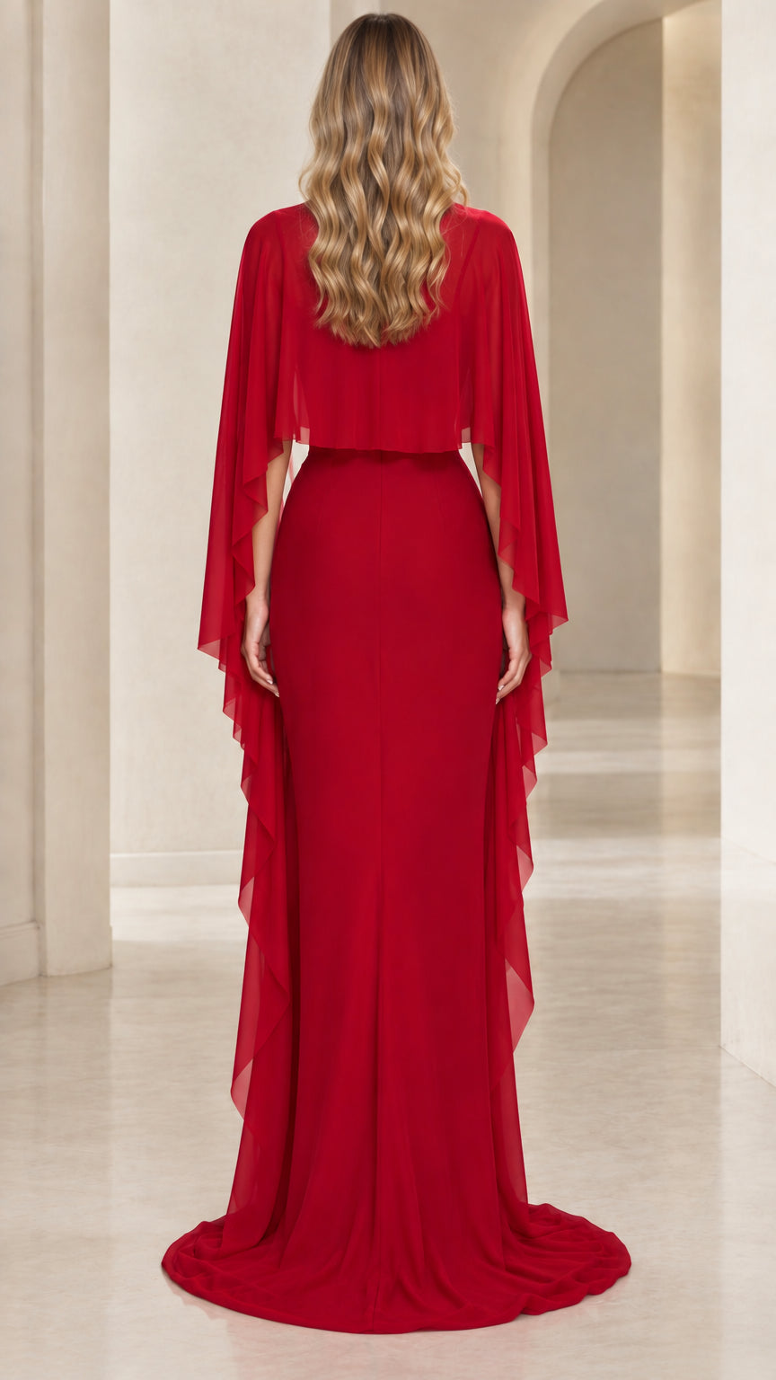 Back view of red evening gown showing flowing sheer cape detail