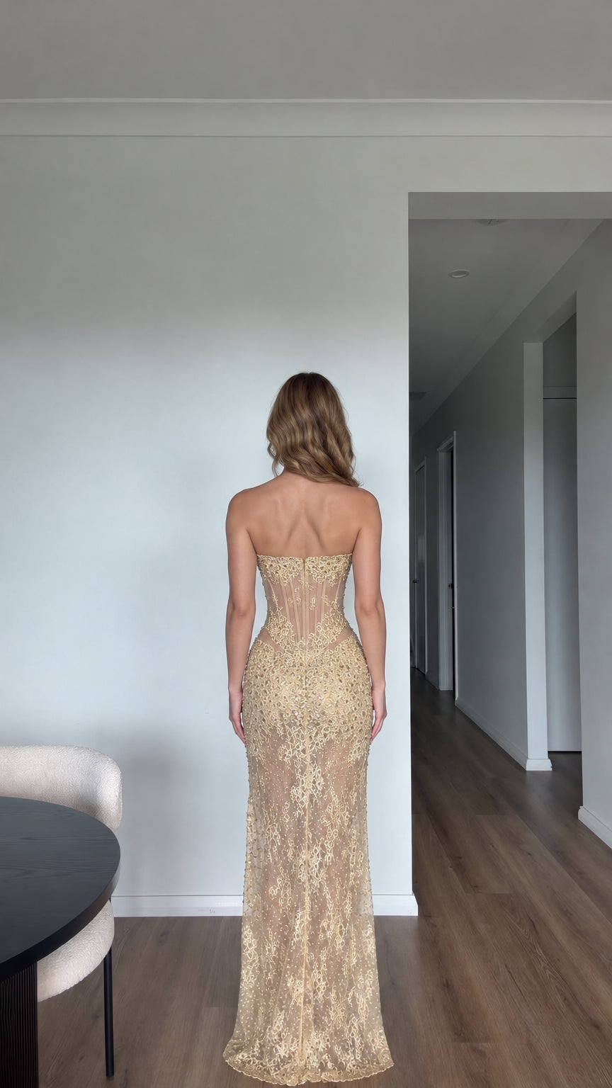 Back view of gold embellished floor length corset evening gown