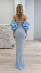 Back view of light blue beaded gown showing lace-up corset and dramatic puff sleeves
