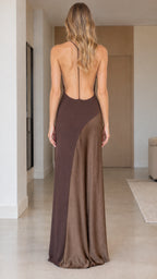 Back view of model showcasing low backless cut on brown satin maxi dress