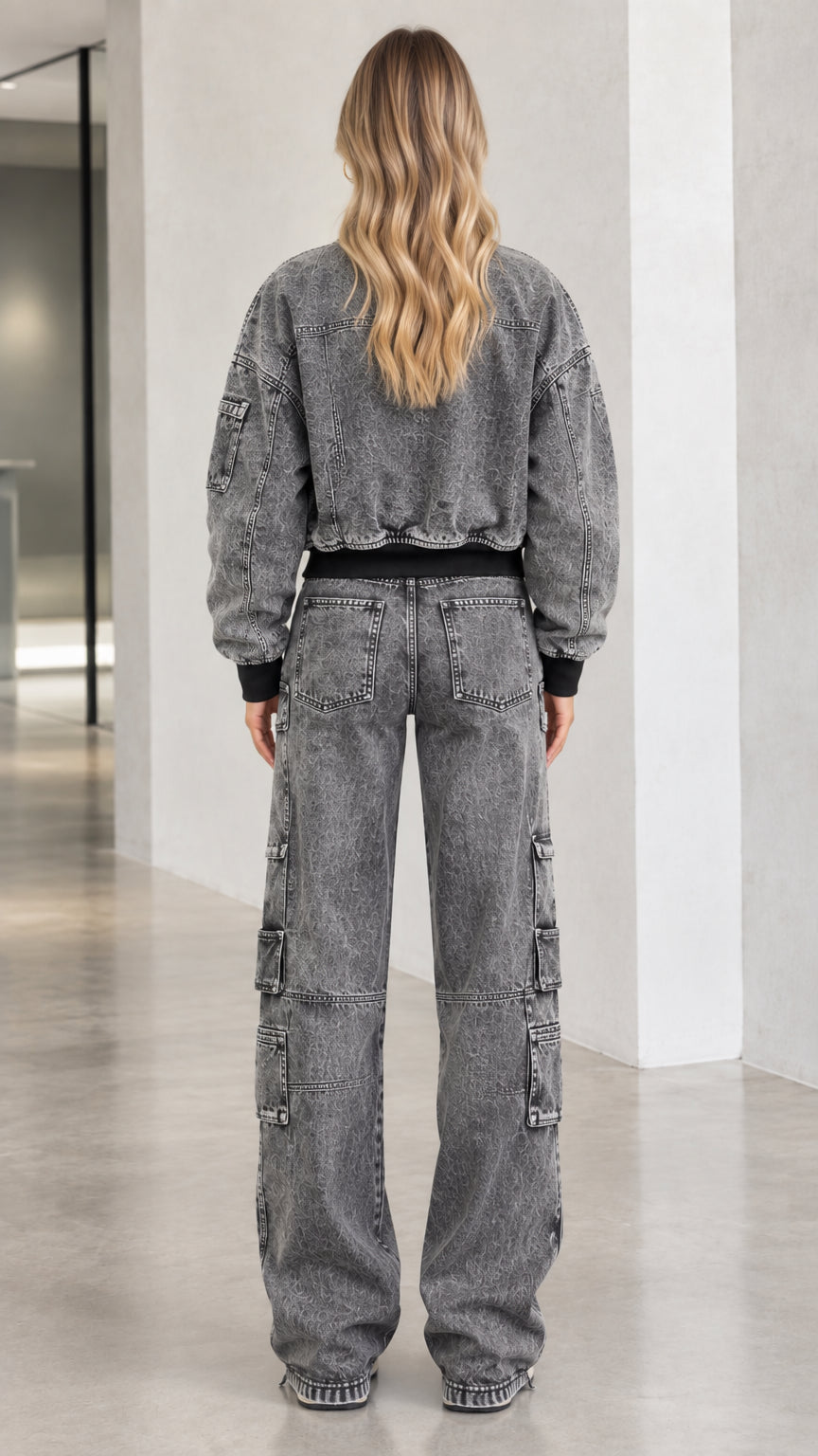 Back view of model wearing washed charcoal denim cropped jacket and straight wide-leg cargo pants