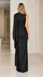 Back view of black sleeveless evening maxi dress highlighting shoulder drape and clean column silhouette