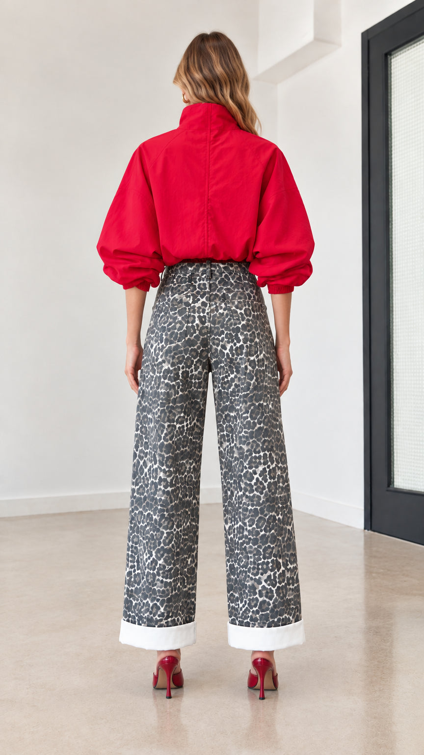 Back view of woman wearing red long sleeve top and grey printed wide-leg pants