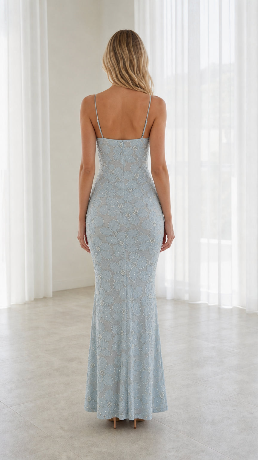 Back view of model wearing Light Blue floor-length spaghetti strap dress