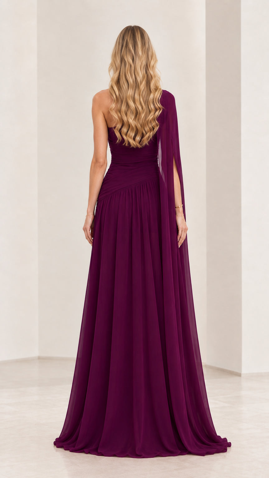 Back view of plum strapless evening gown with asymmetric draped shoulder cape