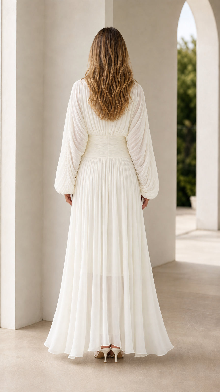 Back view of white long sleeve pleated formal maxi dress