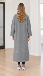 Back full-length view of model wearing grey long bouclé coat