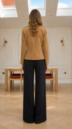 Back full-length view of model wearing camel faux suede jacket showing tailored back seams