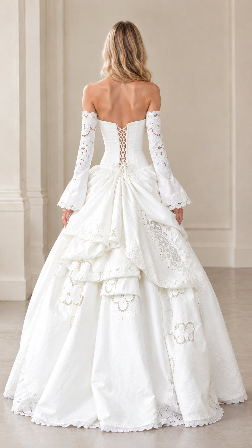 Back view of ivory corset gown highlighting lace-up tie closure and bustle drape