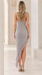 Back view of woman wearing silver sleeveless glitter cocktail dress showing low back