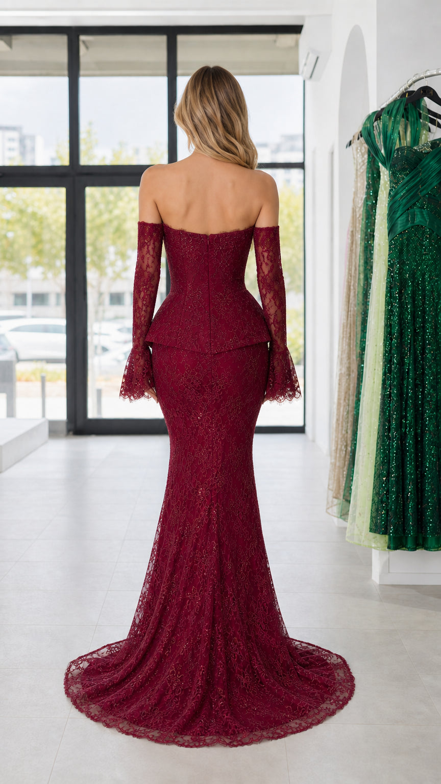 Back view of woman wearing burgundy lace mermaid formal gown showing floor-length train