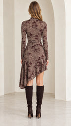 Back full-length view of mocha brown floral mock neck dress showing draped asymmetrical hemline