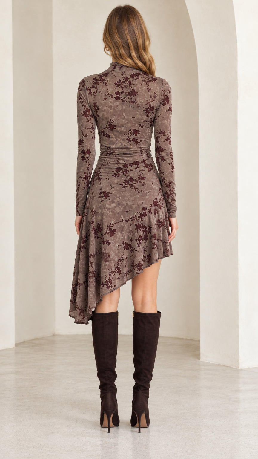 Back full-length view of mocha brown floral mock neck dress showing draped asymmetrical hemline