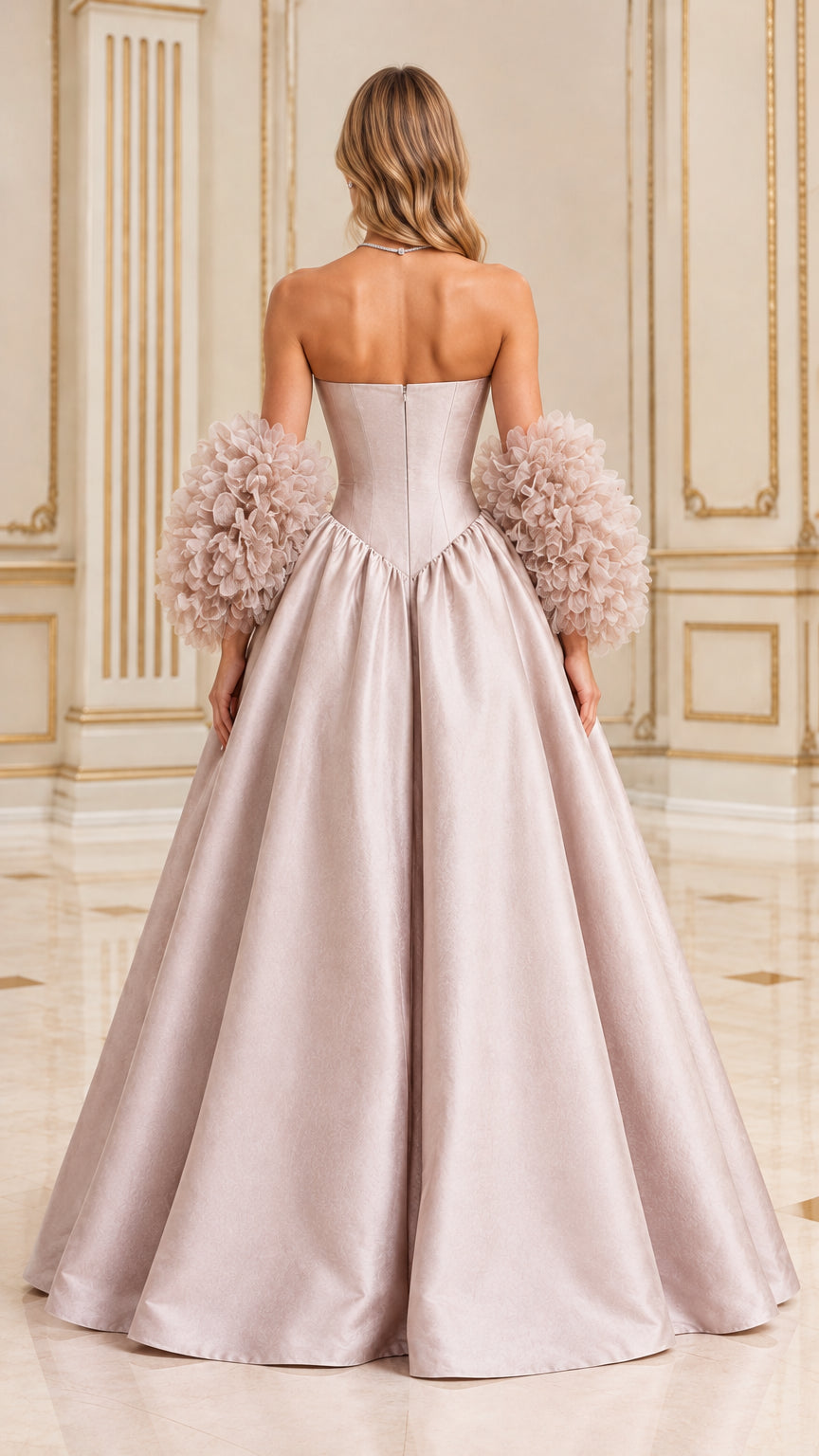 Back view of model wearing dusty pink basque waist formal gown with textured sleeve cuffs