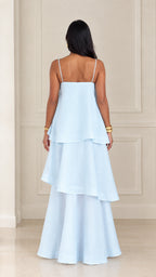 Back view of woman wearing light blue tiered spaghetti strap maxi dress