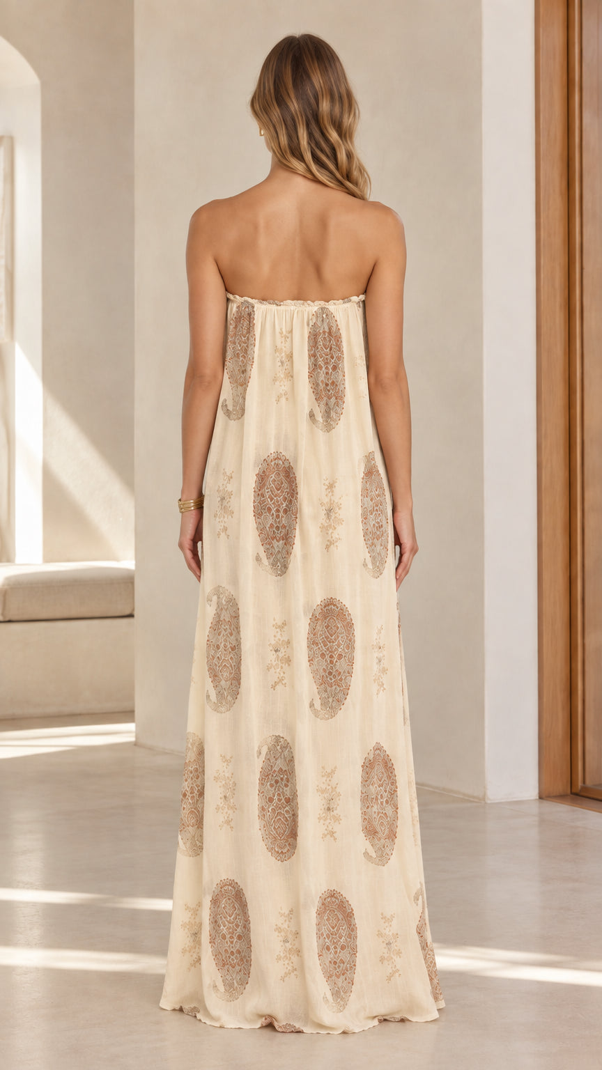 Model wearing beige bohemian paisley strapless maxi dress back view