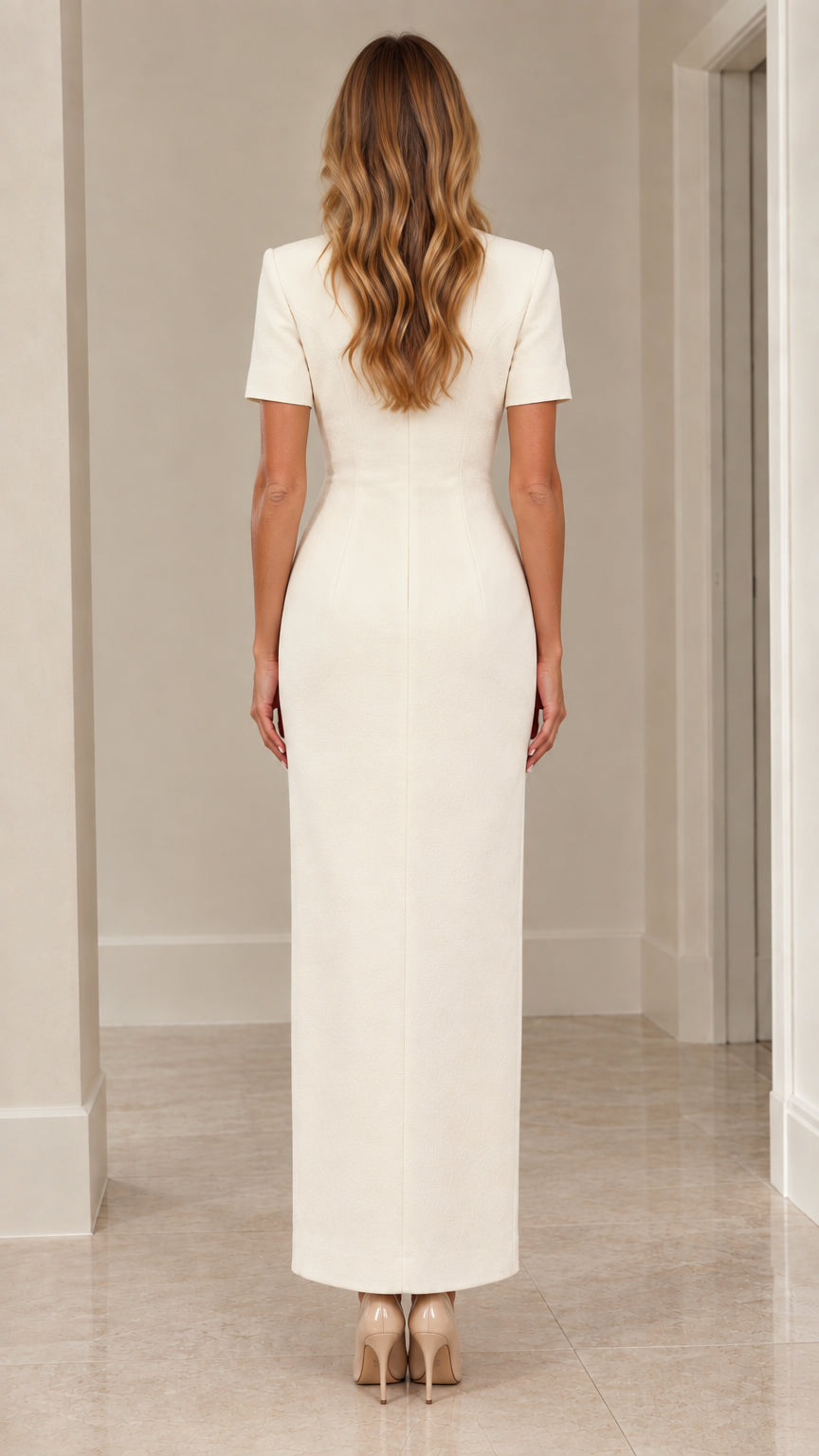 Back view of woman wearing ivory tailored column maxi dress with back zipper