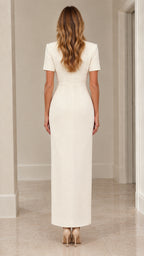 Back view of woman wearing ivory tailored column maxi dress with back zipper